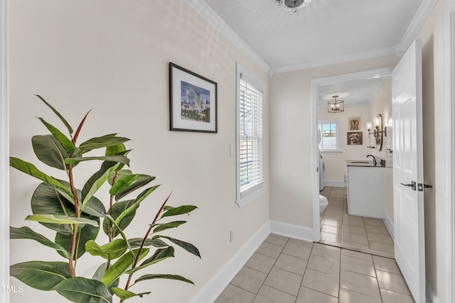 corridor featuring crown molding and light tile patterned floors