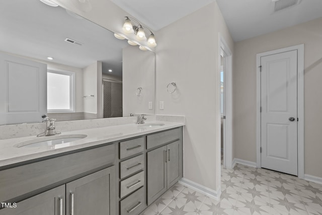 bathroom featuring vanity and a shower with shower door