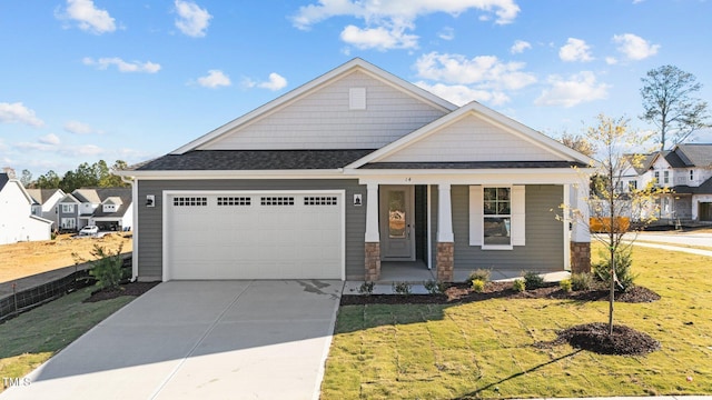 craftsman-style house featuring a garage and a front lawn