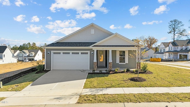 craftsman house featuring a garage and a front lawn