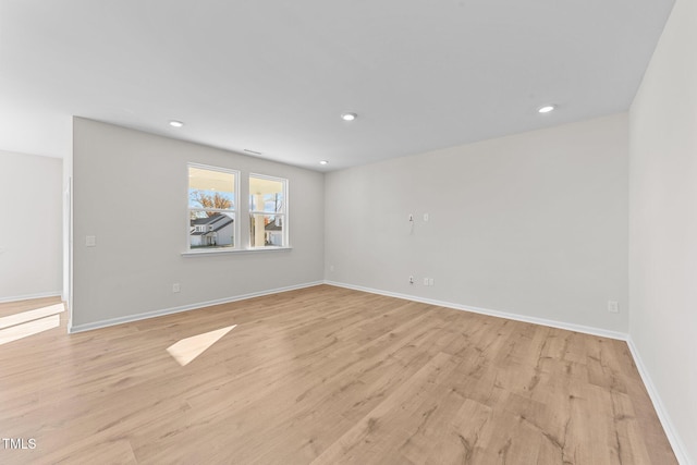 empty room with light hardwood / wood-style floors