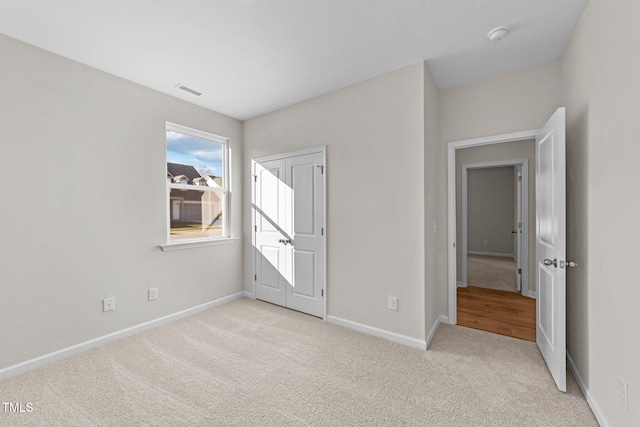 unfurnished bedroom featuring light colored carpet