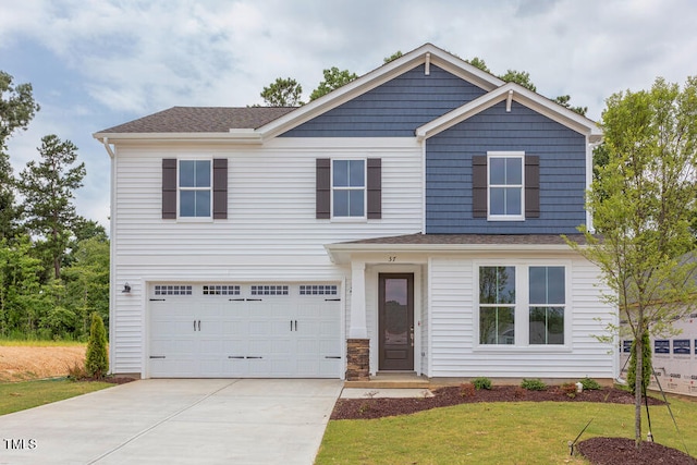 craftsman-style house with a garage and a front lawn