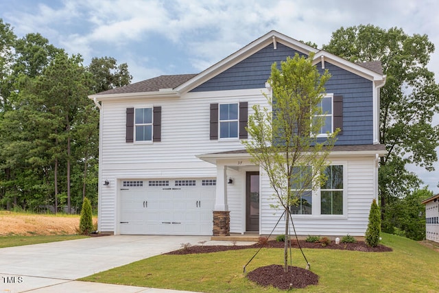 view of front of home with a garage and a front yard