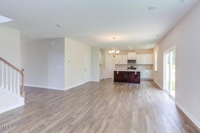 interior space featuring an inviting chandelier and wood-type flooring