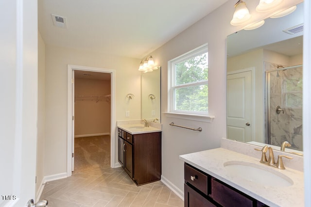 bathroom featuring vanity and a shower with door