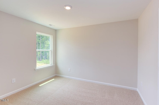 empty room featuring light carpet