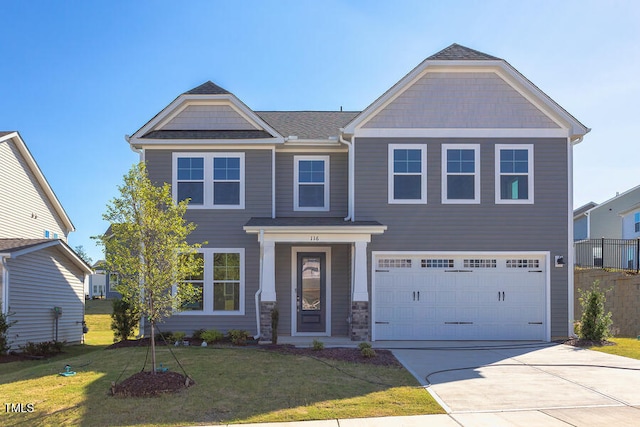 view of front of house with a garage and a front lawn