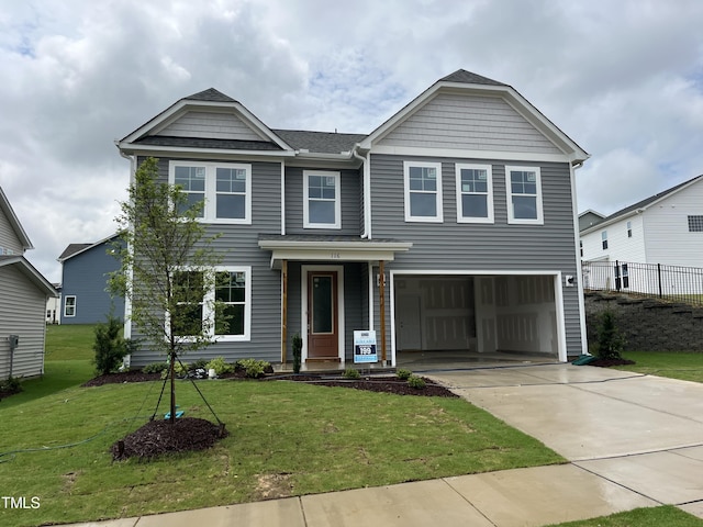 view of front of house with a garage and a front yard