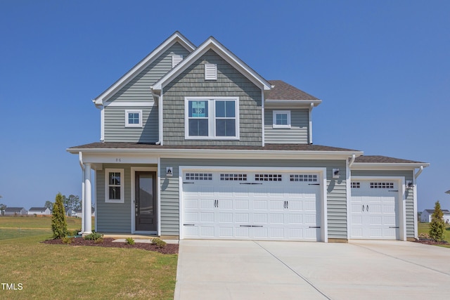 view of front of home with a garage and a front lawn