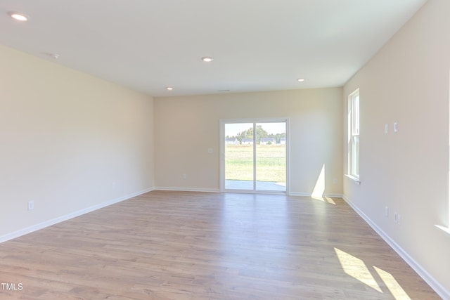 empty room with light hardwood / wood-style flooring