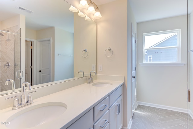 bathroom featuring vanity and a shower with door