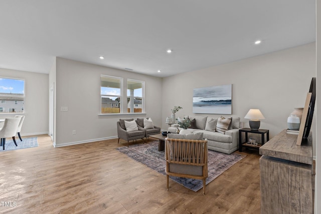 living room featuring light hardwood / wood-style flooring and a wealth of natural light