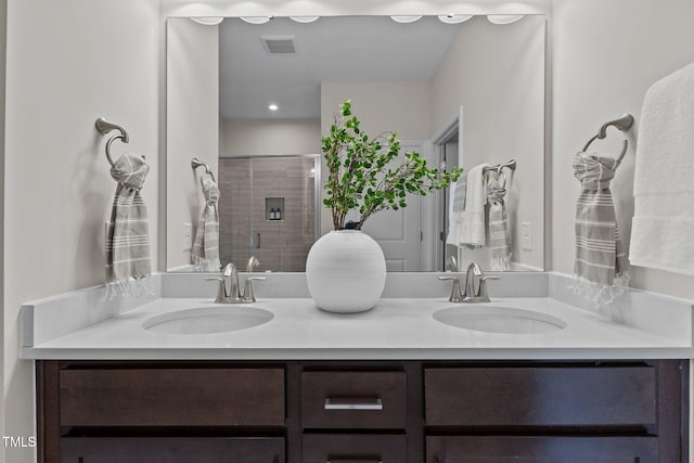 bathroom featuring vanity and a shower with door