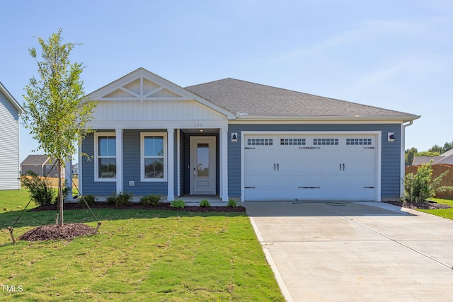 view of front of home featuring a garage and a front lawn