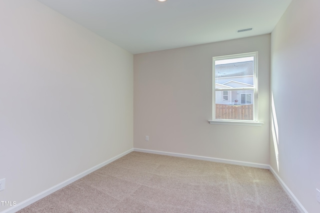 unfurnished room with light carpet