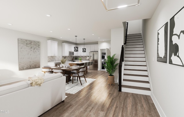 living room with stairs, recessed lighting, wood finished floors, and baseboards