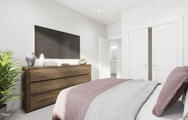 carpeted bedroom featuring ensuite bathroom and a closet