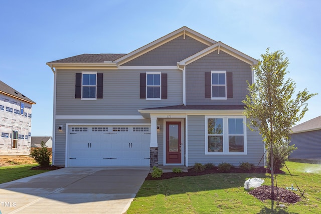 view of front facade with a garage and a front lawn