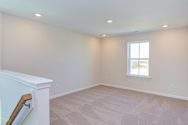 spare room featuring light colored carpet