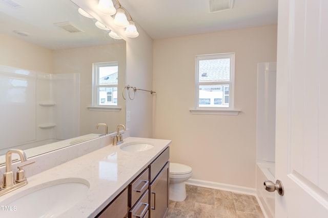 bathroom with vanity, toilet, and a healthy amount of sunlight