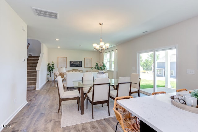 dining room with a chandelier and light wood-type flooring