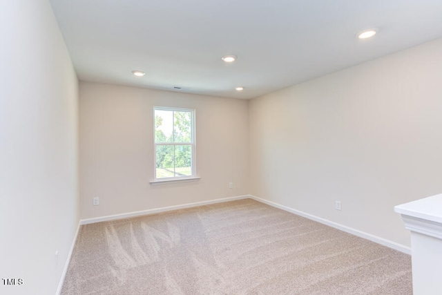 unfurnished room with light colored carpet