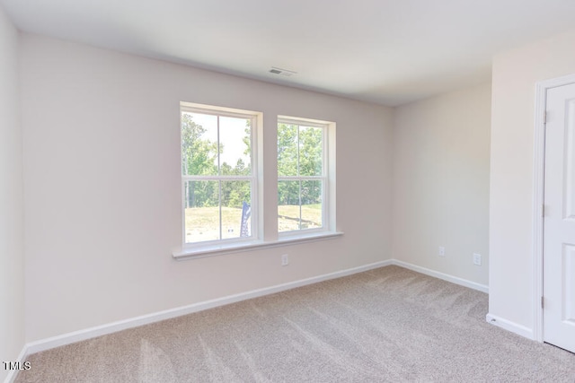 spare room with light colored carpet