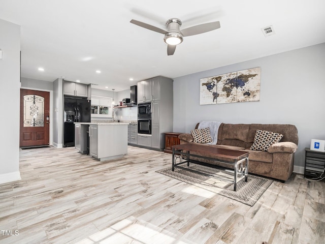 4236 Lake Ridge Dr, Raleigh, NC 27604 - living room featuring ceiling fan, sink, and light wood-type flooring