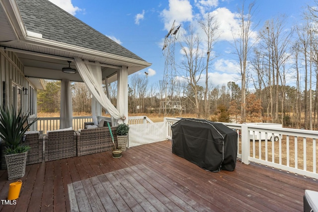 wooden terrace featuring a grill