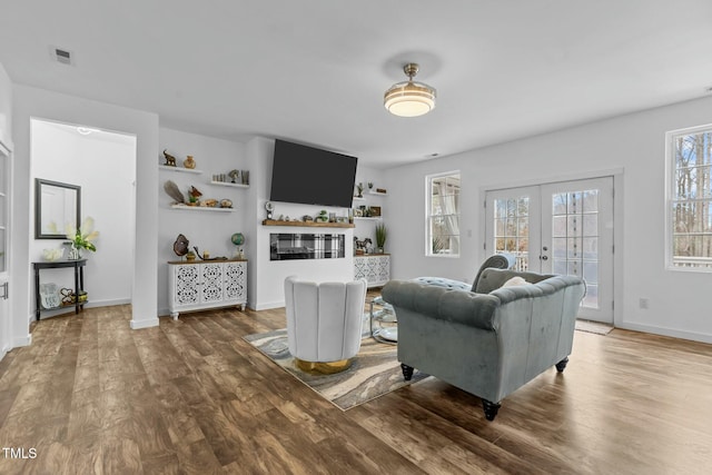 living room with french doors and hardwood / wood-style flooring