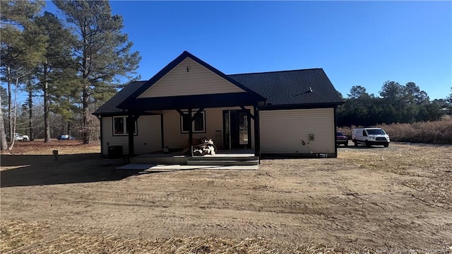 rear view of property featuring cooling unit and a porch