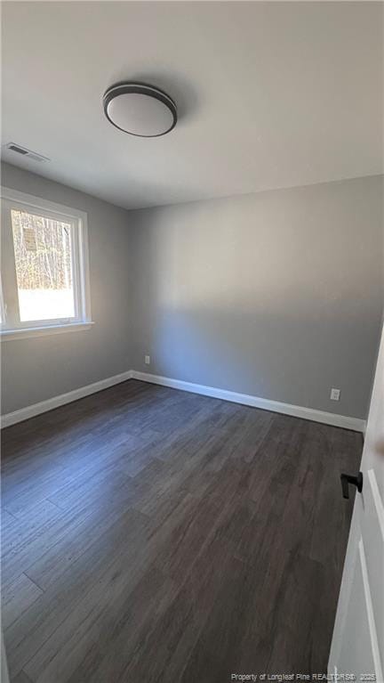 spare room featuring dark hardwood / wood-style flooring