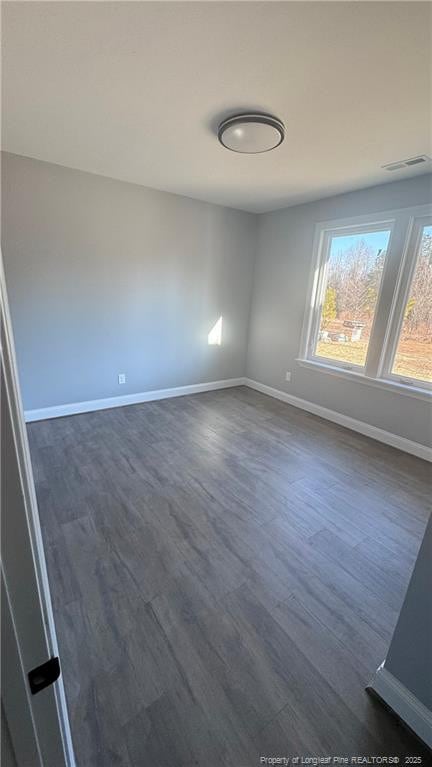 spare room with dark hardwood / wood-style floors