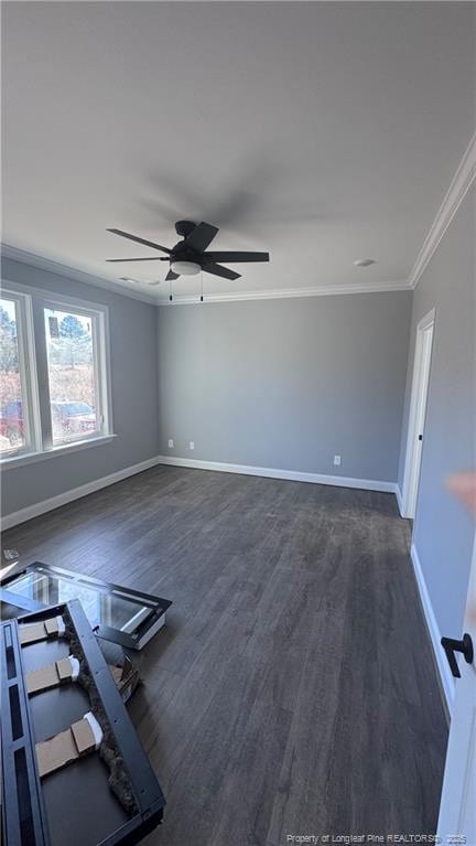 empty room with dark wood-type flooring, ornamental molding, and ceiling fan