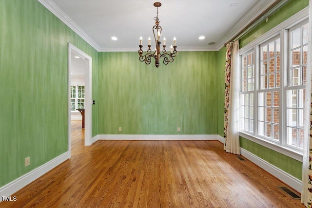 unfurnished room with a chandelier, ornamental molding, baseboards, wood finished floors, and recessed lighting