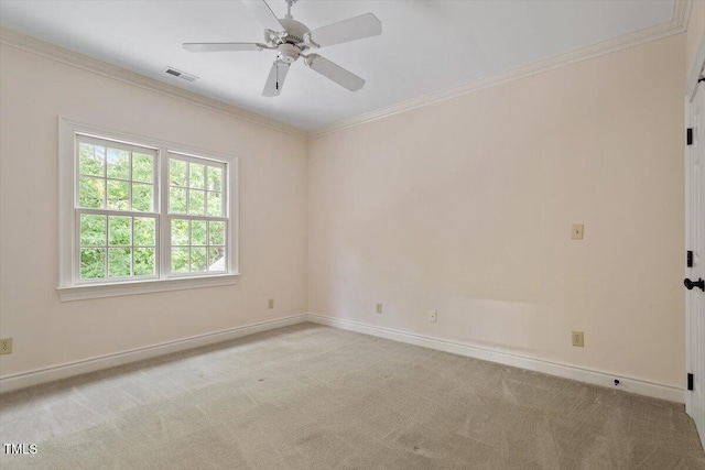 empty room featuring carpet, baseboards, crown molding, and a ceiling fan