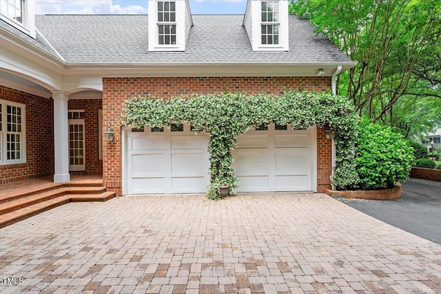garage featuring decorative driveway