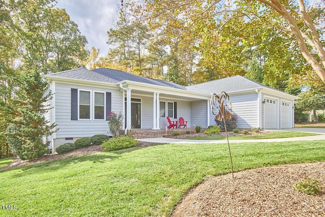 ranch-style home featuring a garage, covered porch, and a front yard