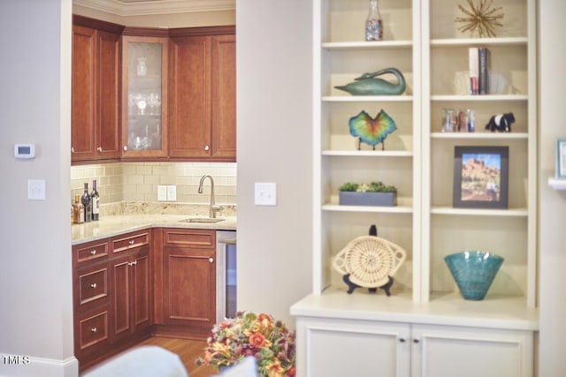 kitchen featuring light stone counters, sink, and decorative backsplash