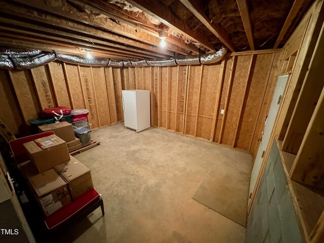 basement with white refrigerator