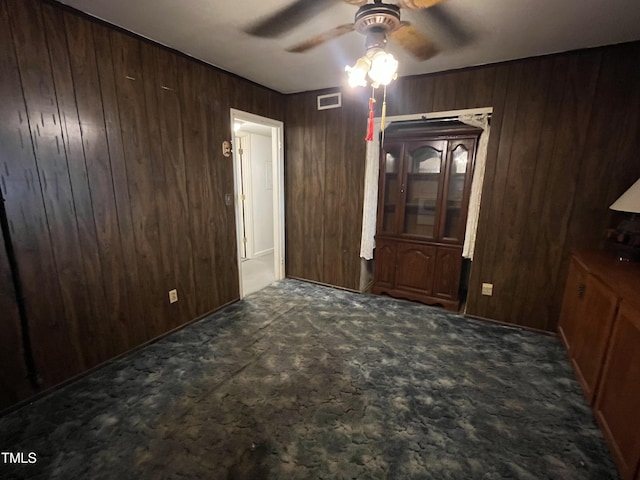 2612 Academy St, Sanford, NC 27332 - unfurnished dining area with ceiling fan, wooden walls, and carpet floors