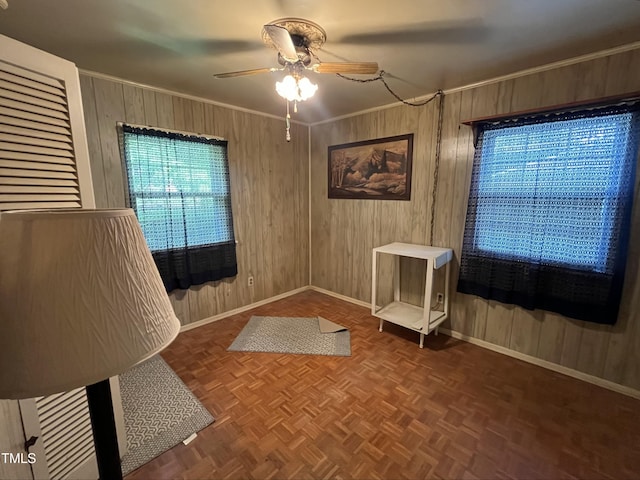 2612 Academy St, Sanford, NC 27332 - empty room featuring baseboards, ceiling fan, wooden walls, and crown molding