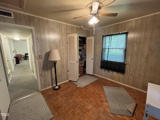 2612 Academy St, Sanford, NC 27332 - entrance foyer featuring wooden walls, baseboards, ceiling fan, and ornamental molding