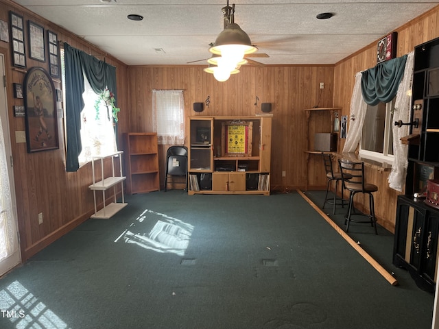 2612 Academy St, Sanford, NC 27332 - carpeted living area featuring wooden walls, baseboards, and a ceiling fan