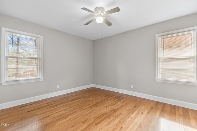 spare room featuring light hardwood / wood-style floors and ceiling fan