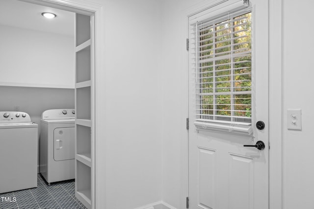 washroom with tile patterned flooring, a wealth of natural light, and washing machine and dryer