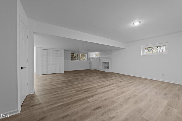 unfurnished living room featuring a fireplace and light wood-type flooring