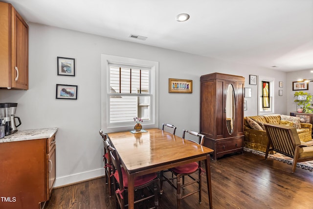 dining space featuring dark hardwood / wood-style flooring