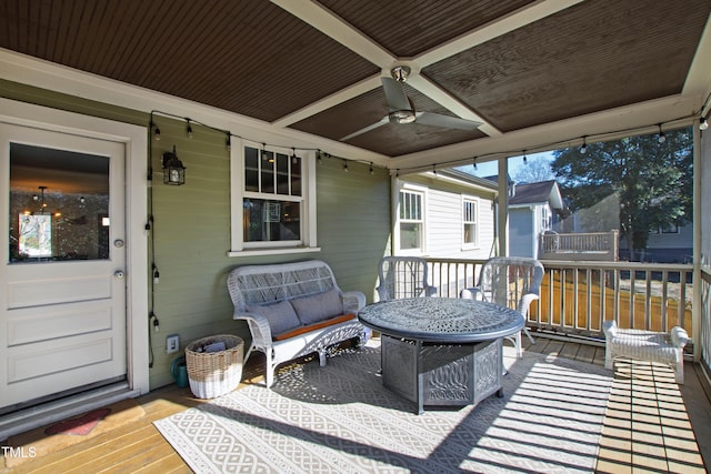 wooden deck with ceiling fan and an outdoor living space